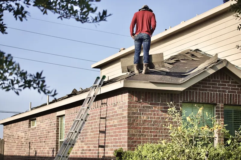 Professional roofer working on a residential roof in Hamilton Hills